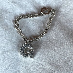 Costume jewelry silver bracelet with the letter G in rhinestones
